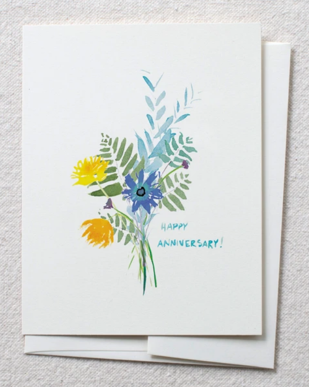 photo of card with watercolor flower and fern bouquet and text reading 'happy anniversary'