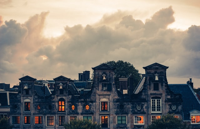photo: old house with orange light coming out all the windows