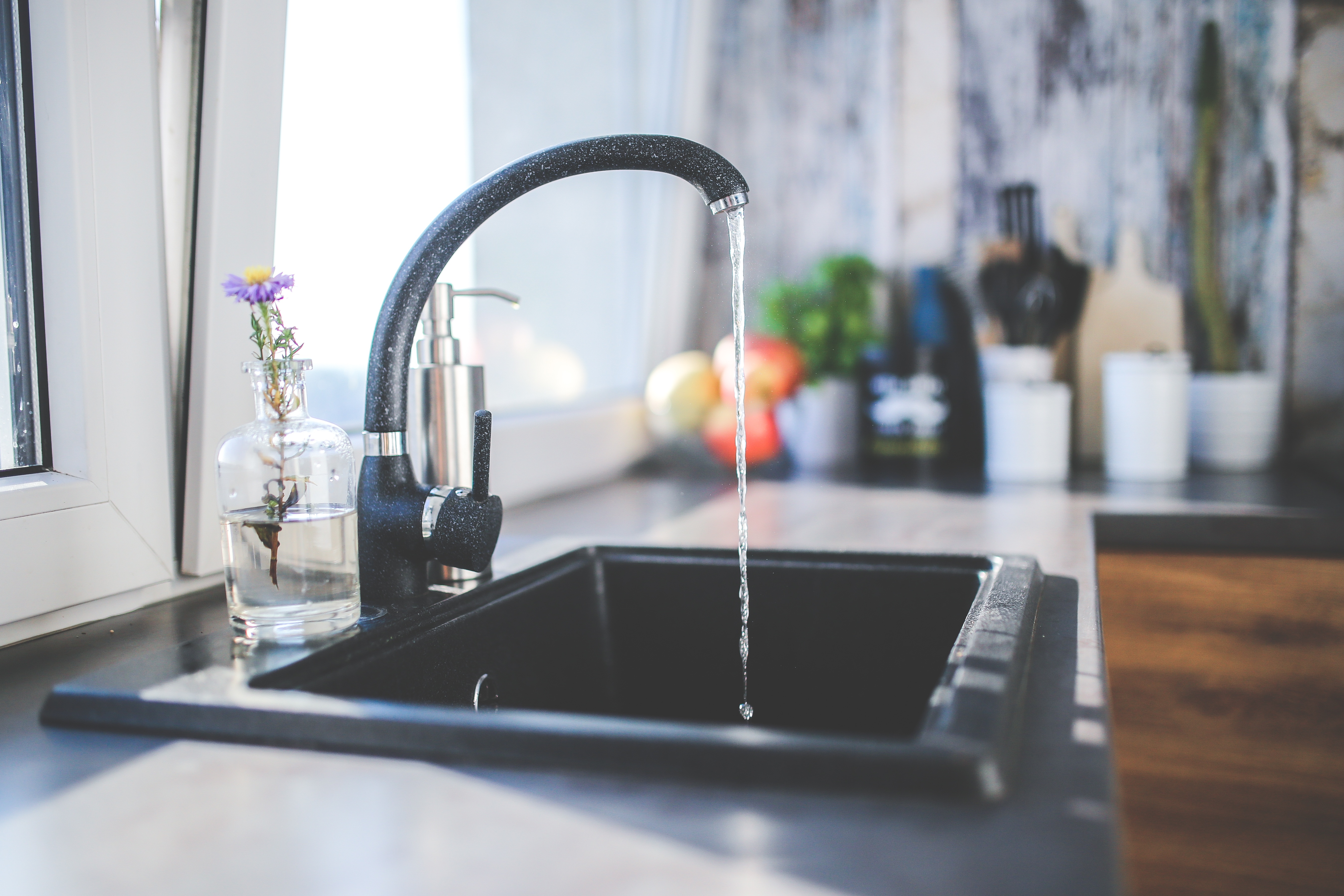 black faucet with water running