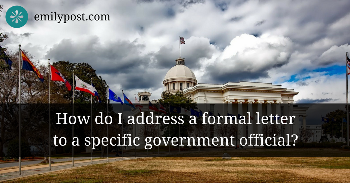 Government building with multitude of flags and text overlay that asks, 