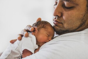 father holding his newborn child