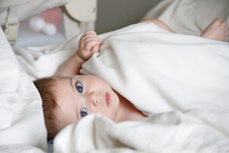 photo: baby in blanket looking up