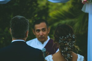 wedding officiant at the alter with the bride and groom