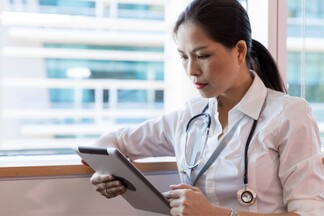female doctor reviewing information on a tablet