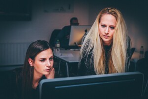 business women looking at a computer screen together