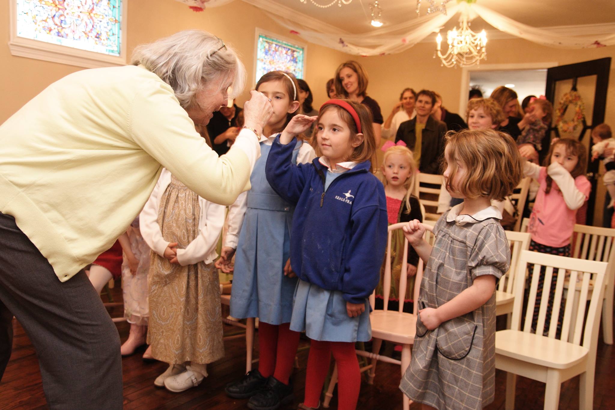 cindy post senning teaches a group of preschoolers how to sign goodbye in ASL